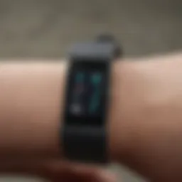 A sleek Fitbit device displaying health metrics